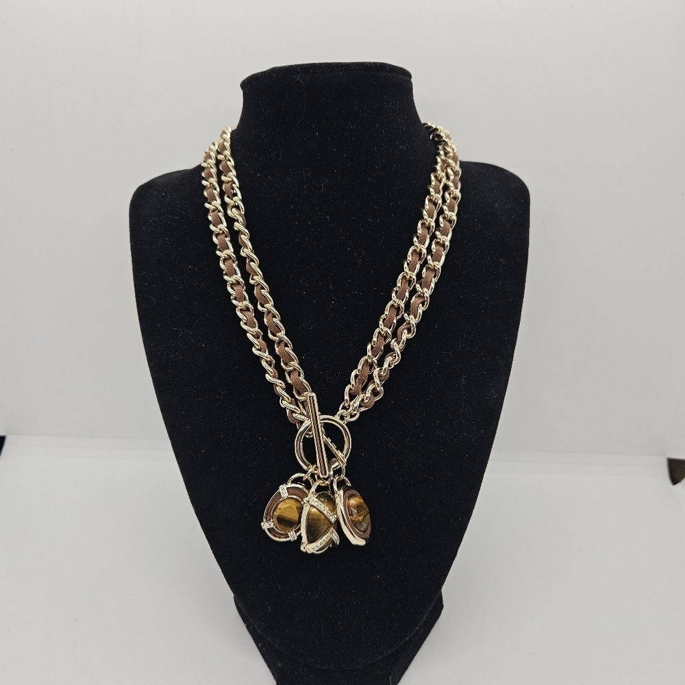 White House Black Market heavy gold tone necklace with tigers eye charms